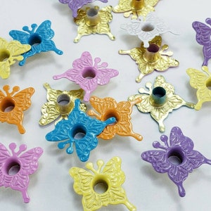 May include: Assortment of colorful metal butterfly charms with a hole in the center. The butterflies are in various colors, including pink, purple, blue, yellow, orange, and green.