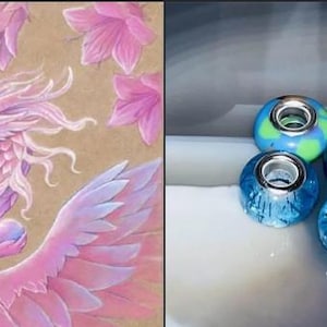 May include: A pink and purple winged dragon with a pearl in its claws. The dragon is surrounded by pink flowers on a brown background. On the right side of the image, there are four blue and green glass beads with silver accents.