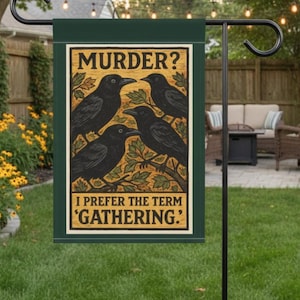 May include: A dark green garden flag with the text "MURDER? I PREFER THE TERM 'GATHERING.'" features four black crows perched on branches. The flag is displayed outdoors on a black metal stand, with a background of greenery and a seating area.
