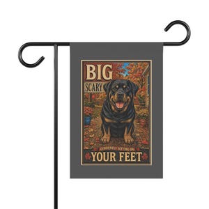 May include: A rectangular garden flag featuring a Rottweiler dog sitting on a porch with autumn foliage. The text reads BIG SCARY CURRENTLY SITTING ON YOUR FEET. The flag is displayed on a black metal stand against a solid gray background.