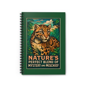 May include: Green spiral-bound notebook with a vibrant illustration of a leopard amidst lush foliage. The cover displays the text: "NATURE'S PERFECT BLEND OF MYSTERY AND MISCHIEF."