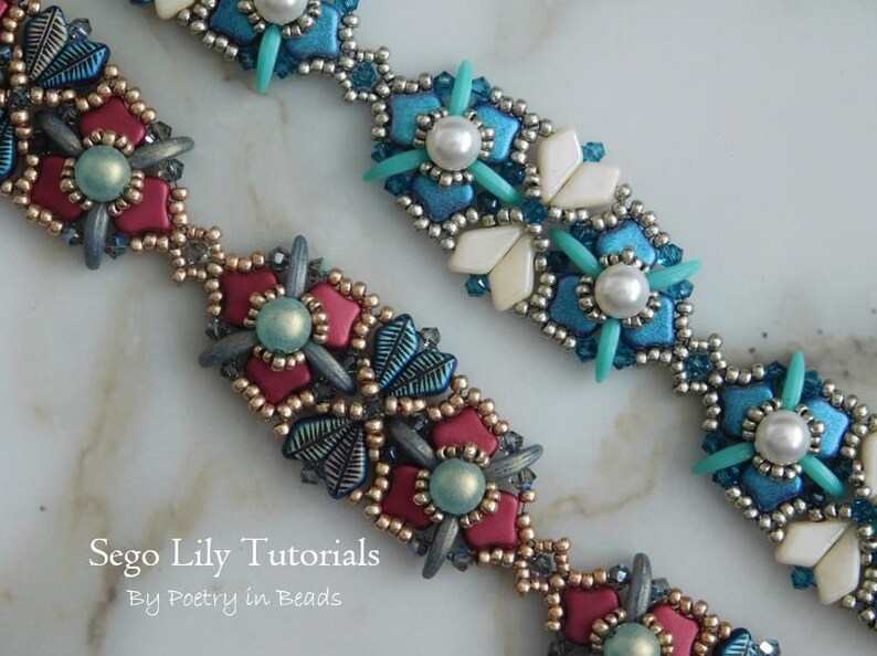 May include: Two beaded bracelets with intricate floral designs. One bracelet features red and blue beads, while the other features white, blue, and silver beads. The bracelets are on a white marble surface. Sego Lily Tutorials by Poetry in Beads.