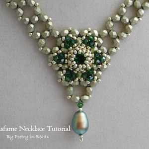 May include: A green and silver beaded necklace with a large green gemstone pendant. The necklace is made with small, faceted beads and has a delicate, intricate design. The pendant is a teardrop shape and has a pearlescent finish.