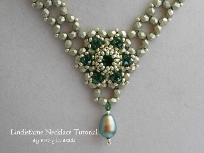 May include: A green and silver beaded necklace with a large green gemstone pendant. The necklace is made with small, faceted beads and has a delicate, intricate design. The pendant is a teardrop shape and has a pearlescent finish.