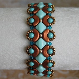 May include: A turquoise and copper beaded bracelet with a geometric pattern. The bracelet is made with small, round beads and larger, faceted beads.