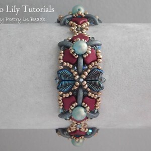 May include: A beaded bracelet with a repeating pattern of burgundy, blue, and gold beads. The bracelet is on a white surface.