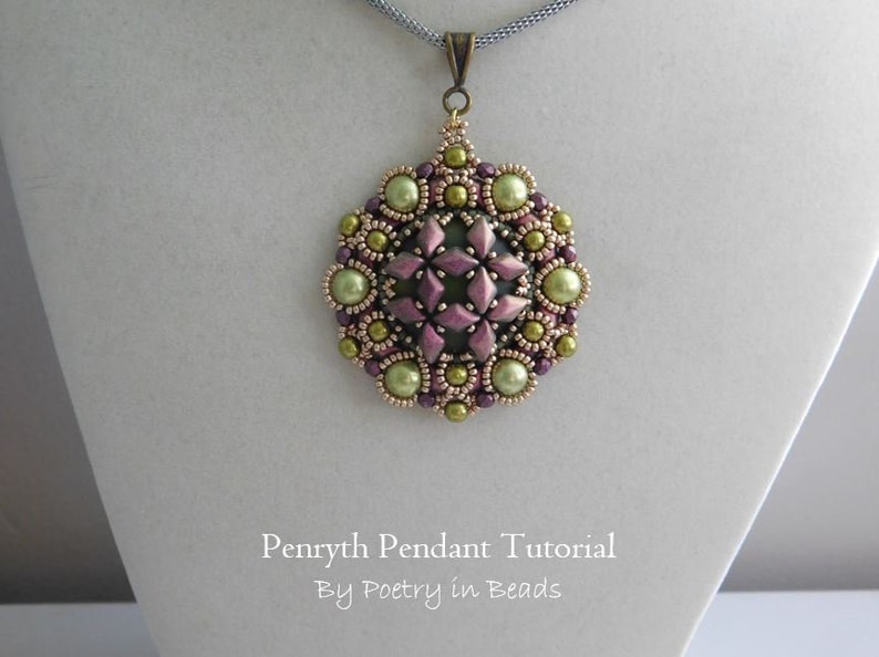 Puede incluir: Un collar con un colgante redondo de cuentas de color verde, dorado y morado. El colgante presenta un dise&ntilde;o de estrella en el centro. El texto "Pennyrth Pendant Tutorial By Poetry in Beads" es visible debajo del colgante.