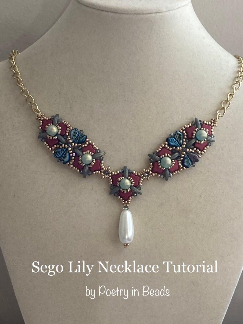 May include: A Sego Lily necklace tutorial by Poetry in Beads, featuring a beaded necklace with a burgundy, blue, and green color scheme and a single pearl drop.