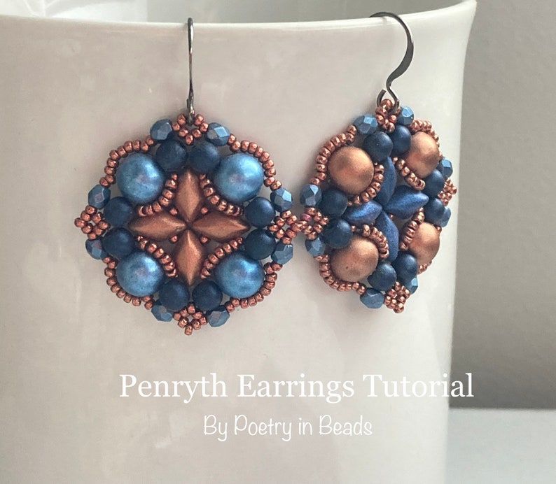 May include: A pair of blue and copper beaded earrings with a starburst design. The earrings are hanging from silver hooks. The text "Penryth Earrings Tutorial By Poetry in Beads" is visible below the earrings.
