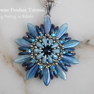 May include: A blue and silver beaded pendant in the shape of a flower. The pendant is made with a variety of beads, including iridescent blue teardrop beads, silver seed beads, and clear crystal beads. The pendant is attached to a silver chain.