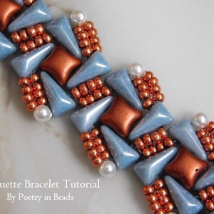 May include: A beaded bracelet with a repeating pattern of light blue, copper, and bronze-coloured beads. The design includes triangular and square beads, with small bronze beads and white pearls. The text "Pirouette Bracelet Tutorial By Poetry in Beads" is visible.