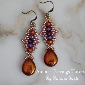May include: A pair of dangle earrings with a geometric design featuring pink, purple, and orange beads. The earrings have a teardrop-shaped pendant made of a metallic orange material. The earrings are labeled "Amunet Earrings Tutorial by Poetry in Beads".