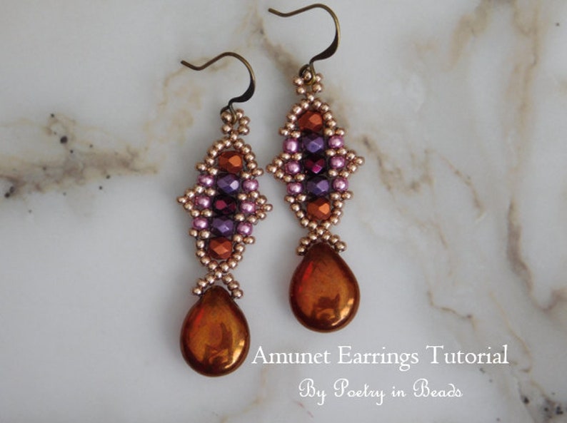 May include: A pair of dangle earrings with a geometric design featuring pink, purple, and orange beads. The earrings have a teardrop-shaped pendant made of a metallic orange material. The earrings are labeled "Amunet Earrings Tutorial by Poetry in Beads".