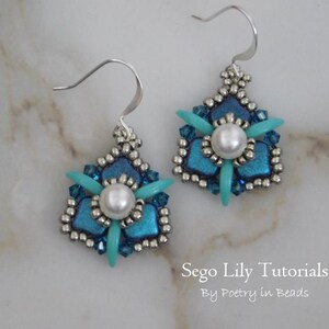 May include: A pair of silver earrings with a blue and turquoise flower design and a white pearl in the center. The earrings are on a white marble surface. Sego Lily Tutorials by Poetry in Beads.
