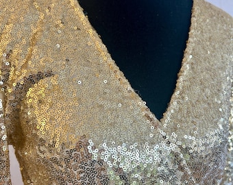 Gouden jumpsuit met lovertjes in jaren 70-stijl