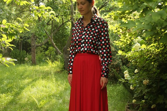 green blouse with white polka dots