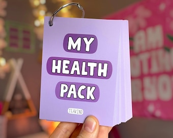 May include: A lavender-colored flipbook with the words "MY HEALTH PACK" in white block letters. The book is held together by a silver metal ring. The brand name "TEAKIND" is printed at the bottom of the cover.