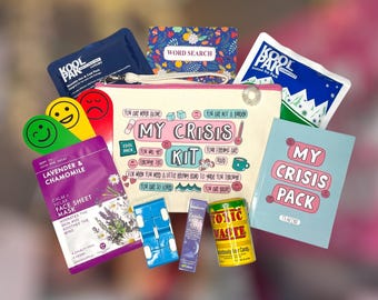 May include: A collection of self-care items, including a canvas pouch labeled "My Crisis Kit," a face mask, a word search, and a small book. The kit also contains a cool pack, a fidget toy, and a lavender roll-on.