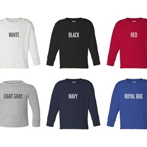 May include: Six long-sleeved shirts in different colors: white, black, red, light gray, navy, and royal blue. Each shirt has a different color text on the front, reading "WHITE", "BLACK", "RED", "LIGHT GRAY", "NAVY", and "ROYAL BLUE".