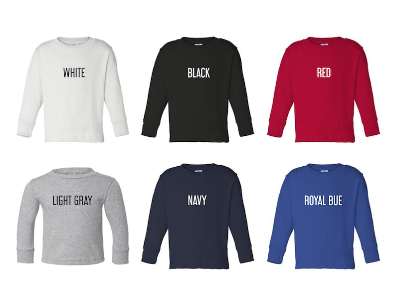May include: Six long-sleeved shirts in different colors: white, black, red, light gray, navy, and royal blue. Each shirt has a different color text on the front, reading "WHITE", "BLACK", "RED", "LIGHT GRAY", "NAVY", and "ROYAL BLUE".