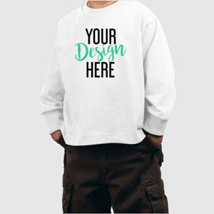 May include: White long-sleeve sweatshirt with the text "YOUR Design HERE" in black and green lettering.