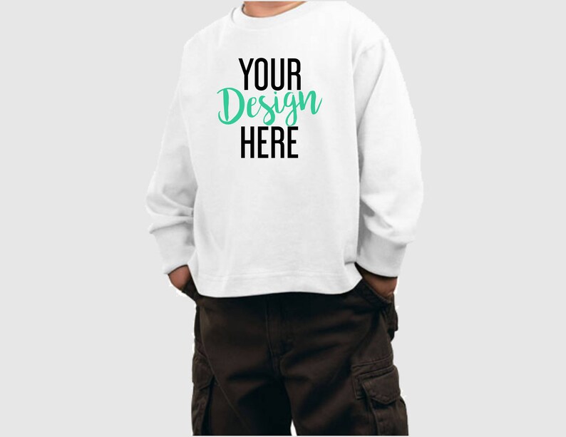 May include: White long-sleeve sweatshirt with the text "YOUR Design HERE" in black and green lettering.