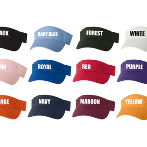 May include: Twelve visors in different colors, each with a different color name printed in white on the front. The colors are black, baby blue, forest, white, pink, royal, red, purple, orange, navy, maroon, and yellow.