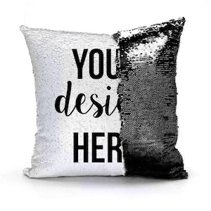 May include: A white and black reversible sequin pillow with the text "YOU design HERE" printed on the white side.