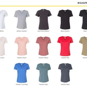 May include: A chart displaying 12 different colours of V-neck t-shirts. The colours are: Solid White, Athletic Heather, Dark Grey Heather, Black Heather, Solid Black, Heather Dust, Heather Peach, Heather Mauve, Heather Red, Heather Olive, Heather True Royal, Heather Slate, and Heather Navy.