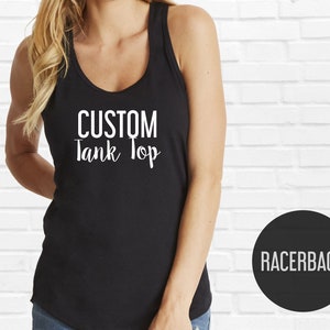 May include: Black racerback tank top with the text "CUSTOM Tank Top" in white lettering.