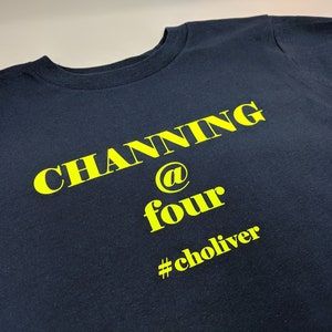 May include: A navy blue t-shirt with yellow text that reads "Channing @ four #choliver".