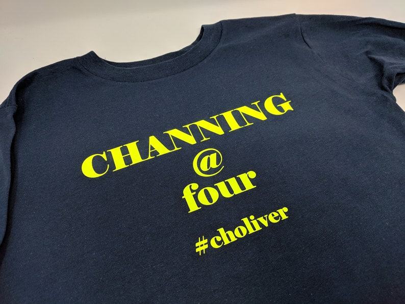 May include: A navy blue t-shirt with yellow text that reads "Channing @ four #choliver".