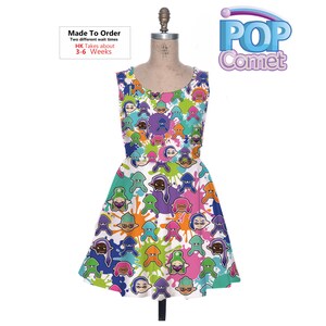 May include: White sleeveless dress with a colorful print of cartoon characters and paint splatters. The print features characters with different colored skin tones and hair. The dress has a flared skirt. The text "Made To Order" and "HK Takes about 3-6 Weeks" is printed on the dress.
