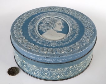 Vintage Tin Blue And Ivory Tin Embossed Made By Fruit Cake Bakers Of America.  B-2