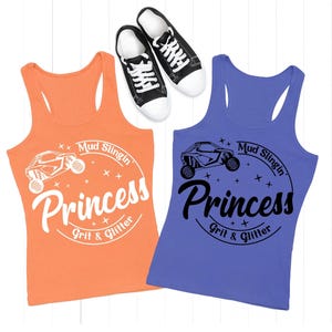May include: Two racerback tank tops, one orange and one purple, with the text "Mud Slingin' Princess Grit & Glitter" and a graphic of an off-road vehicle. Black and white sneakers are at the top.