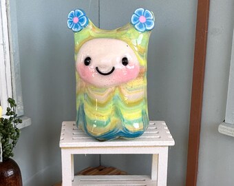 Dalia Sprite is yellow with multi-colored stripes and blue flowers