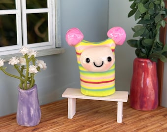Drizzle Sprite yellow with multi-colored stripes and pink Pom poms