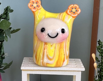 Marigold Spite is yellow swirls with orange marigolds on her ears