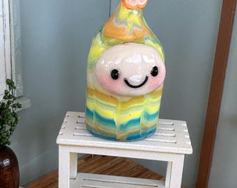 Dizzy Sprite yellow with multi-colored stripes and orange flower