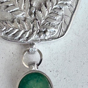Silver pendant necklace with natural emerald