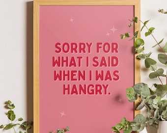 Könnte beinhalten: Ein rosa gerahmter Druck mit dem Text "Sorry for what I said when I was hangry." in roten Buchstaben.