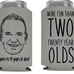 May include: Two gray can coolers with black text. One cooler features a cartoon drawing of a man's face and the text "Cheers to 40 years of Jere!" The other cooler has the text "More fun than two twenty year olds".
