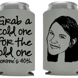 May include: A grey can cooler with a black and white illustration of a woman's face and the text "Grab a cold one for the old one Corinne's 40th".