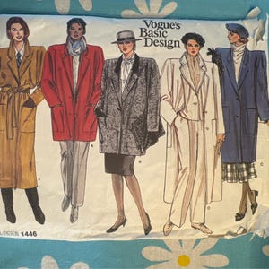 May include: A vintage sewing pattern for four different coats. The pattern is called Vogue's Basic Design and the pattern number is 1446. The coats are in different colors and styles, including a brown coat, a red coat, a gray coat, and a white coat.