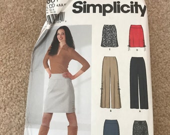 May include: Simplicity sewing pattern with instructions for making a skirt and trousers. The pattern includes five different styles, including a skirt with a leopard print, a red skirt, a pair of wide-leg trousers, a pair of black trousers, and a blue skirt.