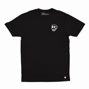 May include: Black t-shirt featuring a white cartoon skull graphic on the front. The skull has large eyes and is surrounded by the text "SLOW WEST". The shirt is made of a soft material and has a crew neck.