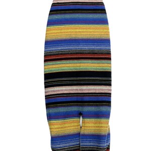 May include: A colorful striped surfboard bag with a drawstring closure. The bag is made of a thick, durable fabric and features a variety of colors, including blue, yellow, red, and green.