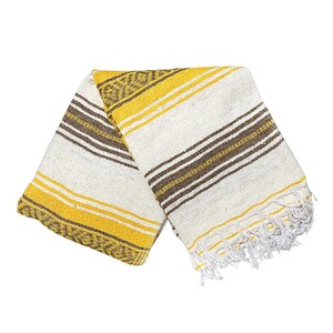 May include: A folded blanket with a striped pattern in yellow, brown, and white. The blanket has a fringed edge and a woven texture. The design includes a decorative border on one end.