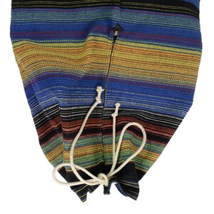 May include: A colorful striped fabric bag with a drawstring closure. The bag is made of a woven fabric with a variety of colors, including blue, red, yellow, and green.