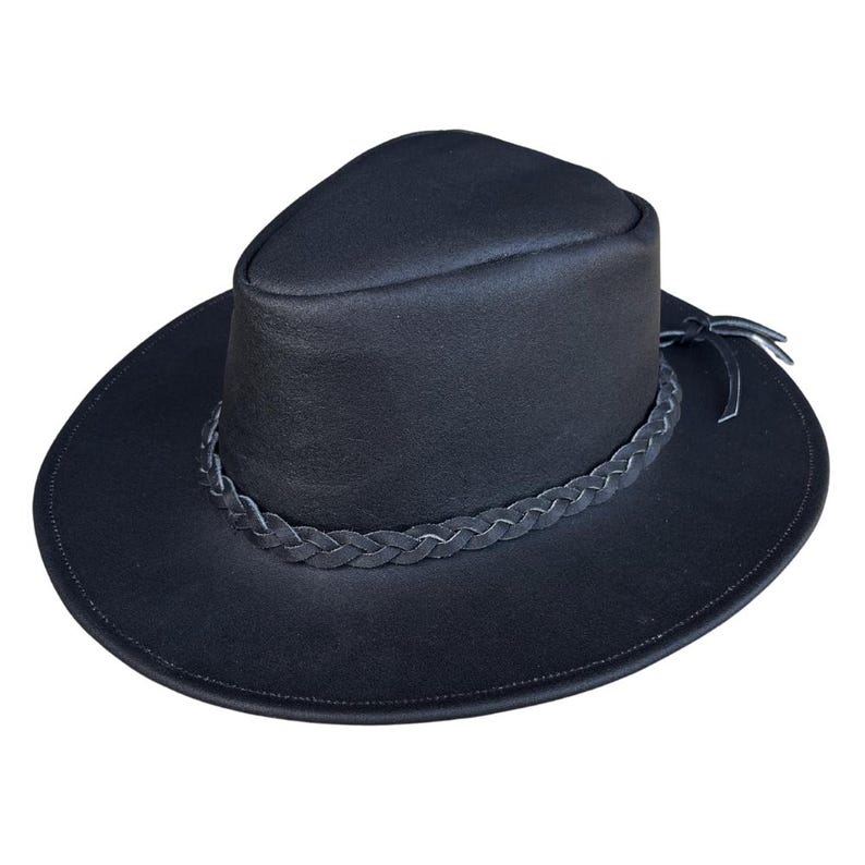 May include: A black hat with a wide brim and a braided leather band. The hat has a rounded crown and a dark leather tie. This hat is a stylish accessory.